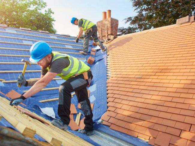 2 men working on a roof